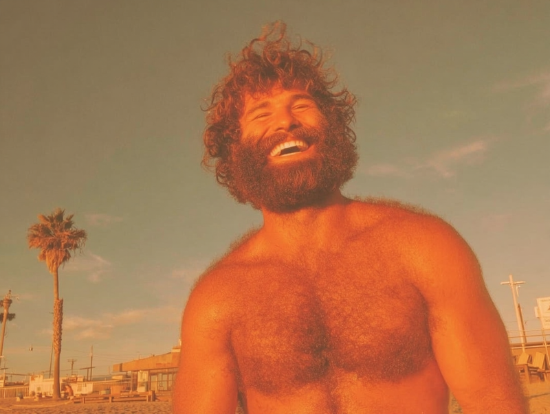 Man with full beard outdoors showing mineral sunscreen white cast on facial hair