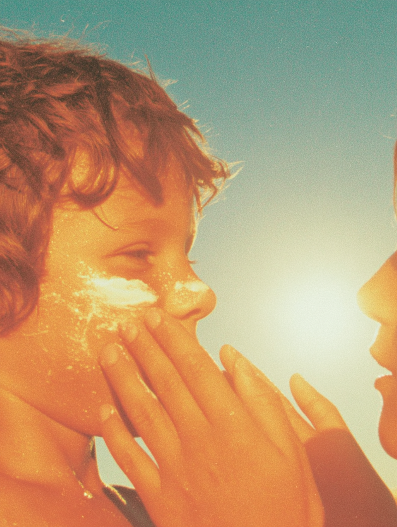 Parent applying sunscreen to child's face before outdoor activity - daily sun protection