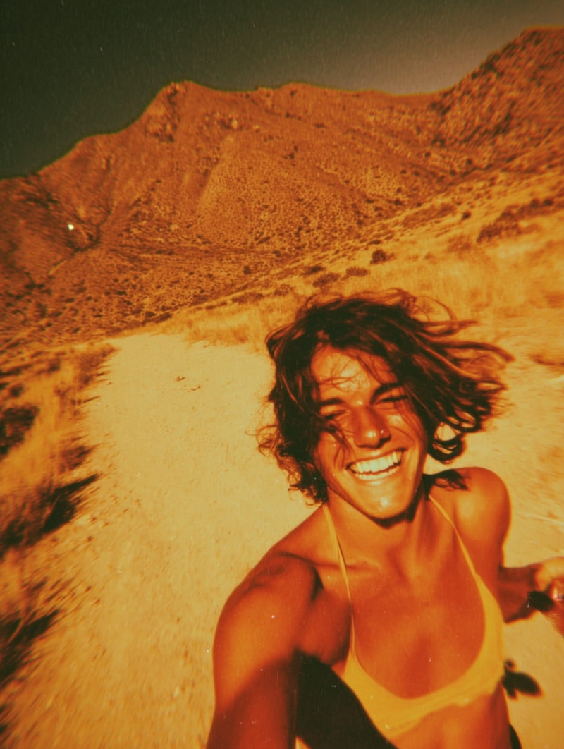 Trail runner in direct sunlight on dusty trail showing matte mineral sunscreen finish on oily skin